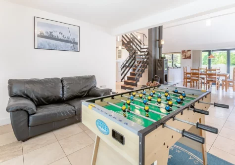 The sitting area with table football at Barn at Little Greenslade, Sampford Courteney
