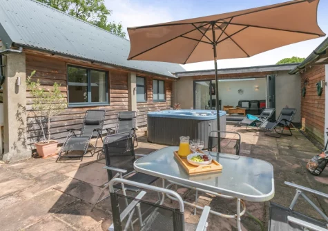 The patio, barbecue & alfresco dining area at Barn at Little Greenslade, Sampford Courteney