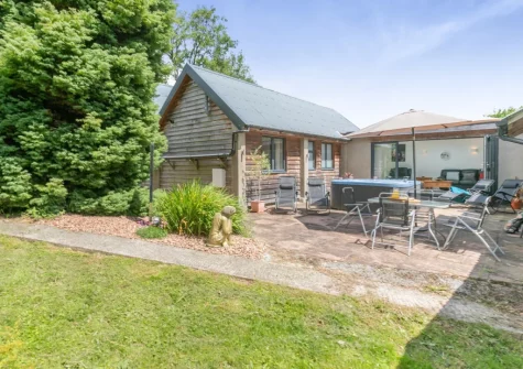 The patio, hot tub, barbecue, alfresco dini at Barn at Little Greenslade, Sampford Courteney