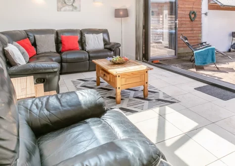 Barn at Little Greenslade, Sampford Courtenney is a stylish two-bedroom cottage nestled in the peaceful Devon countryside, featuring a private hot tub, wood burner, games room, and easy access to dramatic Dartmoor and both Devon coasts.