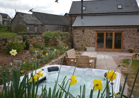 The patio, alfresco dining area & hot tub at Barn View Hill Farm, Uplowman