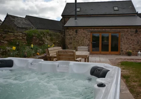 The patio, alfresco dining area & hot tub at Barn View Hill Farm, Uplowman