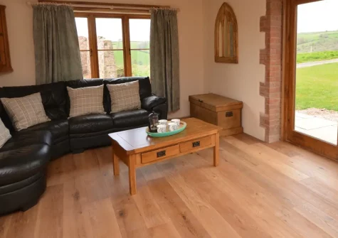 Barn View Hill Farm, Uplowman is a characterful three-bedroom barn conversion on a working farm offering countryside tranquillity with modern luxuries including a hot tub, wood burner, and spacious garden, perfectly positioned to explore Devon.