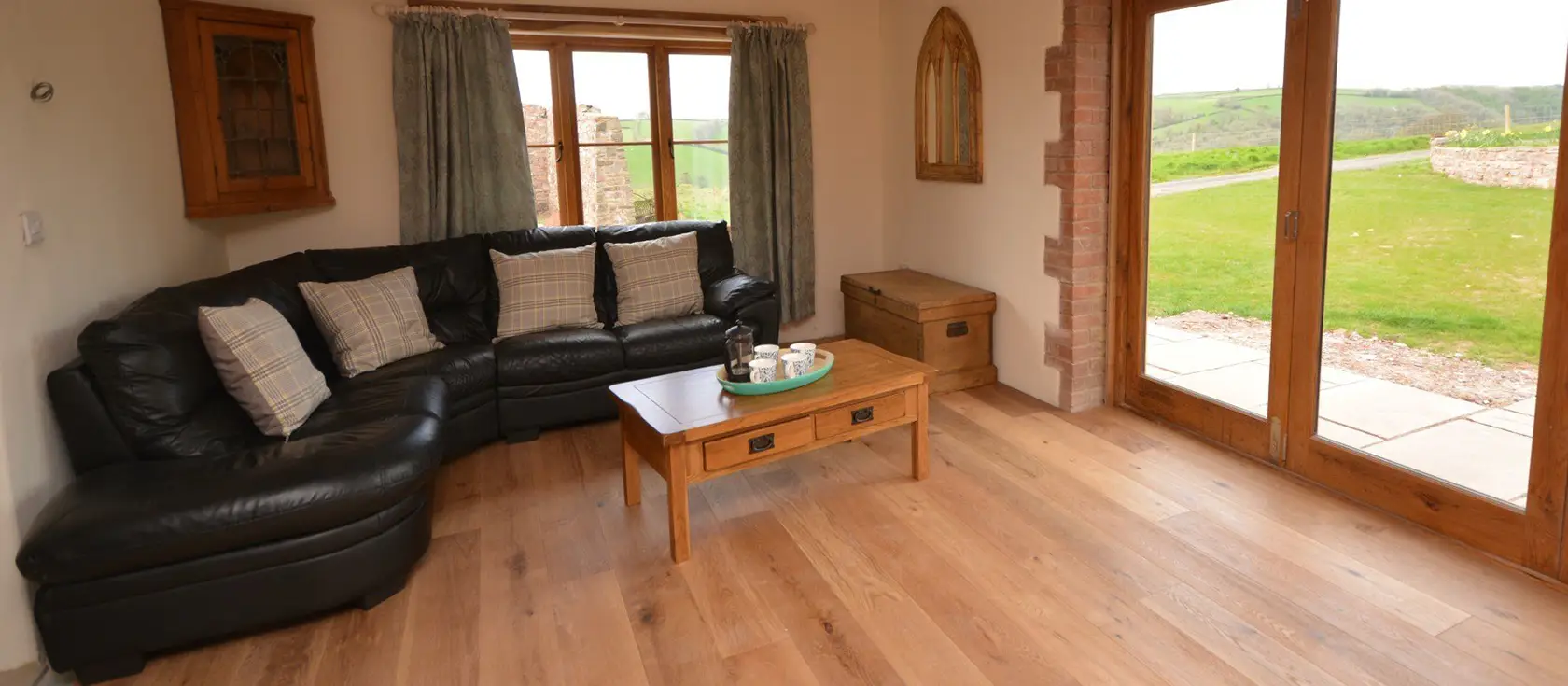 Barn View Hill Farm, Uplowman is a characterful three-bedroom barn conversion on a working farm offering countryside tranquillity with modern luxuries including a hot tub, wood burner, and spacious garden, perfectly positioned to explore Devon.