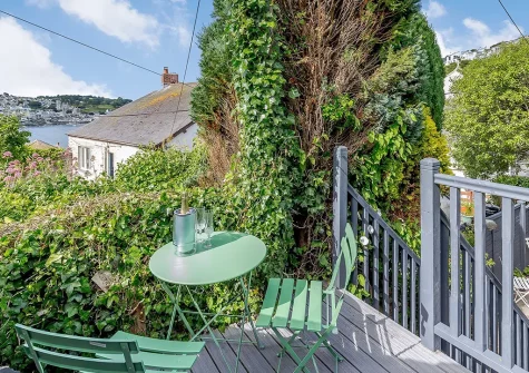 The decked outdoor sitting area & garden at Barney Cottage, Polruan
