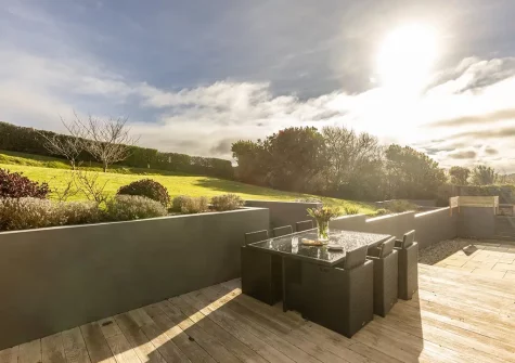 The decked patio, alfresco dining area & rear tiered garden at Bay Ridge, Appledore