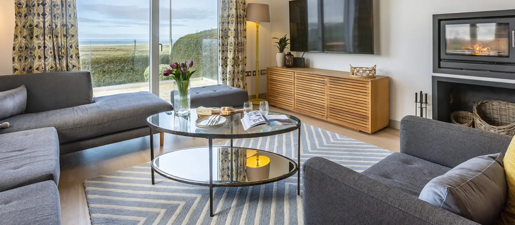 Bay Ridge, Appledore is a luxurious 5-bedroom coastal retreat with panoramic sea views, featuring a games room, wood burner, and tiered garden. Perfect for families and friends seeking a stylish base to explore North Devon's villages and beaches.