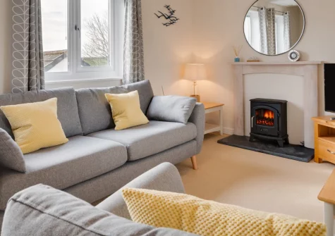 Bay Tree Cottage, Padstow is a charming two-bedroom retreat moments from the harbour, boasting countryside views, a sunny decked patio, cosy interiors, and easy access to beaches, galleries, and the Camel Trail, perfect for a relaxing family getaway.