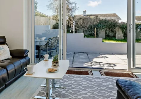 Bay View, Brixham Holiday Park is a two-bedroom chalet-style retreat offering stunning sea views and resort amenities. Enjoy stylish open-plan living, private outdoor spaces, and access to a heated pool, perfect for families seeking a coastal escape.