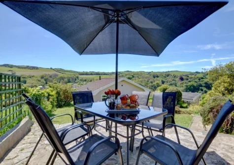 The tiered garden, patio & alfresco dining area at Bay View Bungalow, Combe Martin