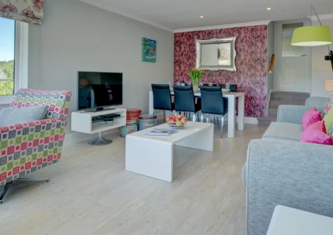 Bay View Bungalow, Combe Martin is a contemporary three-bedroom retreat above this charming coastal village, featuring spectacular sea views from a beautifully tiered garden, modern interiors, and direct access to the dramatic Hangman coastal path.