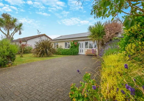 The long front garden & driveway, with parking for two cars, at Bays Reach, Tregolds