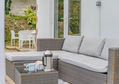 The decked terrace, outdoor sitting area & garden at Beach Walk, Newquay