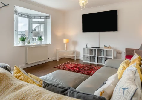 Beach Walk, Newquay is a spacious four-bedroom holiday home located close to Porth Beach, featuring a covered veranda, enclosed garden, flexible sleeping arrangements, and ideal access to Cornwall's finest beaches and family attractions.
