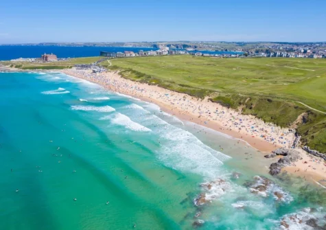 Mere steps away, Fistral Beach is a wide stretch of sand popular with surfers, bathers & families alike