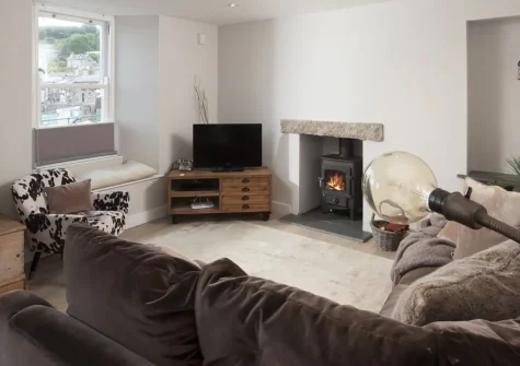 Berlewen, Mousehole is a stunning harbourside cottage with breathtaking harbour views, cosy wood-burner, and unique outdoor shower. Perfect for families seeking authentic Cornish charm just steps from the beach, restaurants, and shops.