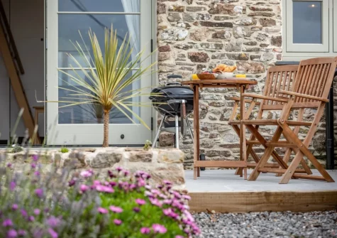 The patio, barbecue area & oudoor sitting area at Birdsong Barn, Combe Martin