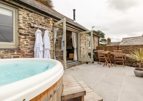 The patio, hot tub & oudoor sitting area at Birdsong Barn, Combe Martin