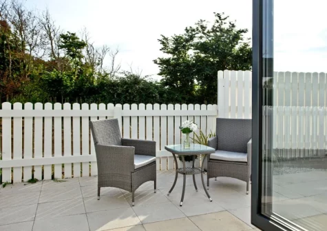 The enclosed patio, hot tub & outdoor sitting area cn be accessed from bedroom #1