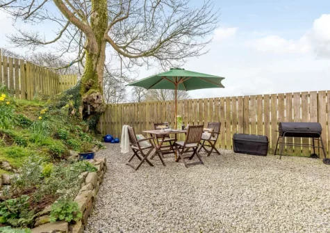 The shingle garden, barbecue & alfresco dining area at Bluebell Barn, Alfardisworthy