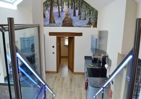 The stairs lead up from the kitchen to the bedroom at Bluebell Barn, Meldon