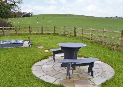 The alfresco dining area, hot tub & enclosed garden at Bluebell Barn, Meldon