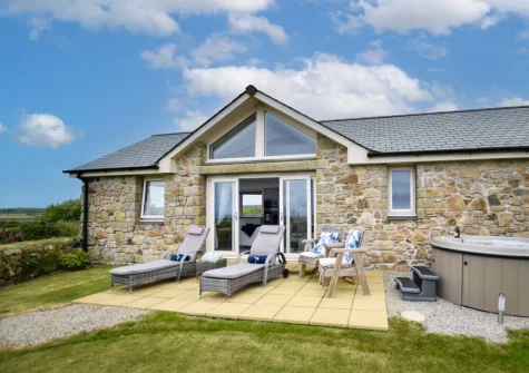 The patio, outdoor sitting area, hot tub & enclosed garden at Bluebell Cottage, St Just