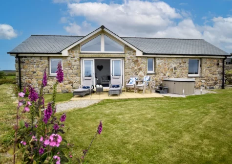 The patio, outdoor sitting area, hot tub & enclosed garden at Bluebell Cottage, St Just