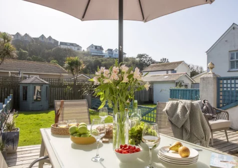 The decked patio, barbecue, alfresco dining & outdoor sitting area at Bluebirds, Polzeath