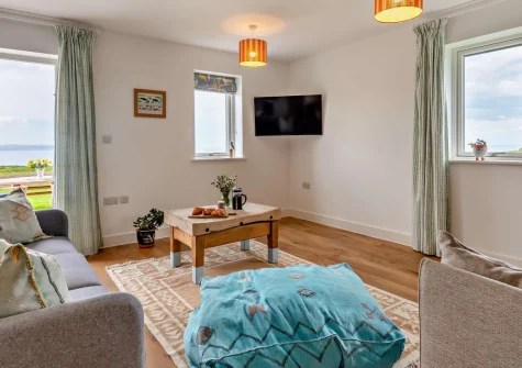Boatlake Barn, Greencliff Farm, Abbotsham is a stylish single-storey barn conversion on a working farm near Westward Ho!, featuring two en-suite bedrooms, an enclosed garden with barbecue, and easy access to golden beaches and coastal walks.