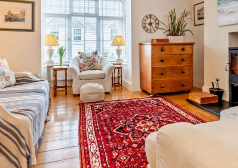 Bobs Cottage, Padstow is a beautifully spacious three-bedroom home steps from the harbour, featuring original character with modern comfort, a sunny tiered patio garden, second-floor snug with sea views, and cosy wood burner for relaxing evenings.