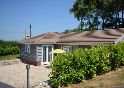 The patio, outdoor sitting area & garden at Borders Edge Lodge
