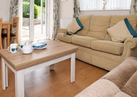 Borders Edge Lodge, Raymond's Hill is a bright two-bedroom retreat ideally placed for exploring the Jurassic Coast, featuring an open-plan living space, private patio and lawn, and easy access to beaches at Lyme Regis, Charmouth and beyond.