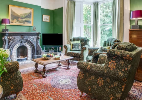 Boslandew House, Mousehole is an elegant seven-bedroom Victorian residence near the coast, featuring a private heated swimming pool, expansive gardens with productive orchard, and gracious period interiors perfect for celebratory family gatherings.