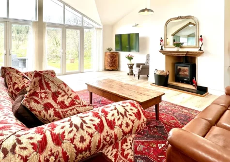 Bourne Lodge, Witheridge is a charming woodland retreat set within 20 acres of private grounds near Witheridge village, featuring exposed beams, a warming wood burner, contemporary comforts, and a private fishing lake surrounded by ancient woodland.