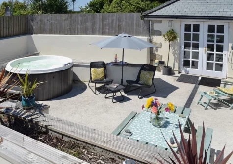 The enlosed courtyard patio, barbecue alfresco dining area & hot tub at Bowji, Kelynack