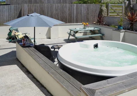 The enlosed courtyard patio, barbecue alfresco dining area & hot tub at Bowji, Kelynack