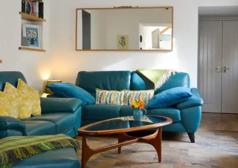 Bowji, Kelynack is an accessible barn conversion set in peaceful countryside near Land's End, featuring a private hot tub, enclosed patio, underfloor heating, and single-storey living close to dramatic cliffs and golden Sennen Beach.
