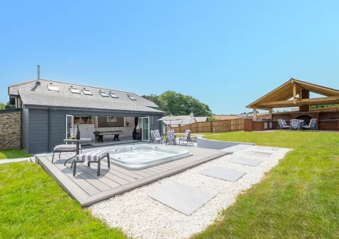 The hot tub, outdoor sitting area & garden at Bowjy, Liskeard