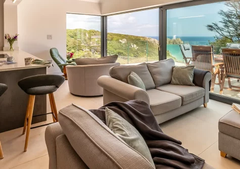 Bracken Bank, Porthcurno, is a luxurious four-bedroom home with stunning views over the beach and ocean. Experience modern elegance, spacious terraces, and proximity to the iconic Minack Theatre—perfect for an unforgettable Cornish coastal escape.
