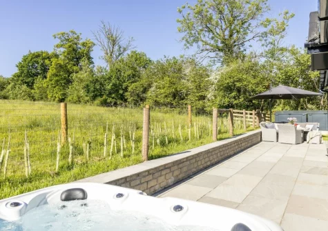 The patio, hot tub & alfresco dining area at Bramble Lodge, 12 Roadford Lake Lodges, Broadwoodwidger