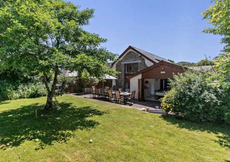 The patio, alfresco dining area & large enclosed lawned garden at Buckland Barn, Buckland Brewer