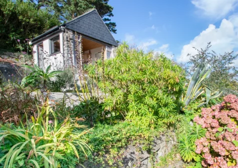 The rear enclosed terraced garden & summerhouse at Bumbles, Mousehole