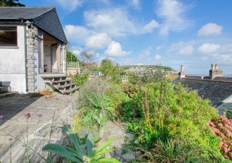 The rear enclosed terraced garden & summerhouse at Bumbles, Mousehole