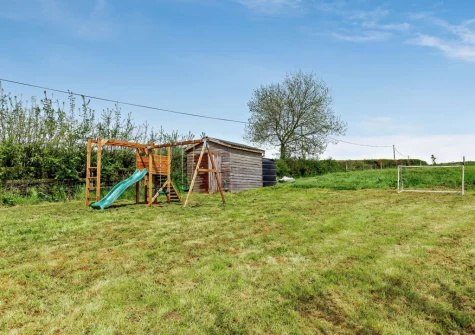 The paddock with children's play area at Burrow Farmhouse, Staple Cross