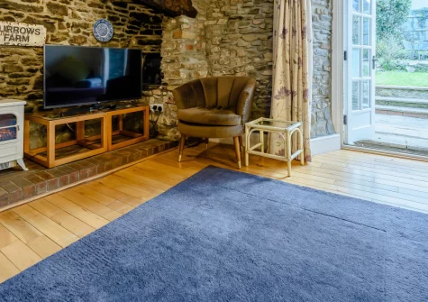 Burrows Farmhouse, Croyde is a delightful Grade II listed thatched cottage set in pretty mature gardens, featuring original features throughout, flexible four-bedroom accommodation, & an idyllic village location just a short distance from the beach.