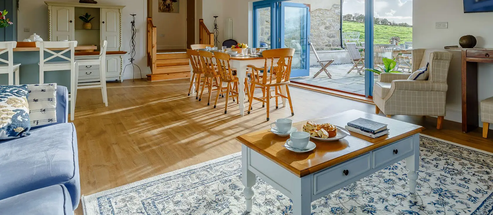 Butter Barn At Pengelly Farm, Nancegollan is a luxurious barn conversion nestled in the Cornish countryside with stylish interiors, bi-fold doors opening to farmland views, and perfect positioning to explore both North and South coast beaches.