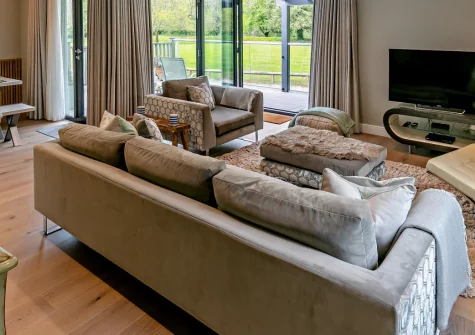 Buttercup at The Camel Trail, Tredethy is a contemporary three-bedroom home with a decked veranda overlooking a wildlife-rich meadow, direct Camel Trail access, and easy reach of Cornwall's coastal villages, beaches and dining out.