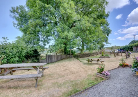 The shared lawn garden & alfresco dining area at Button Stable, Bratton Fleming