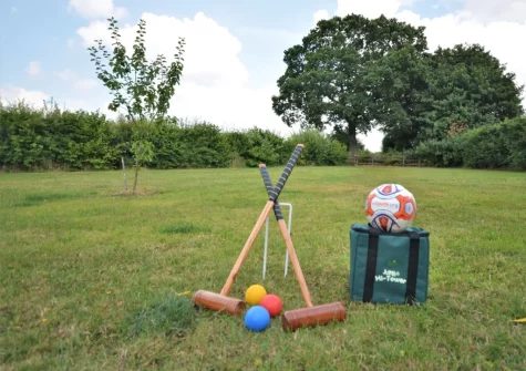 The enclosed lawned garden, with games, at Buzzard Cottage, Sheldon